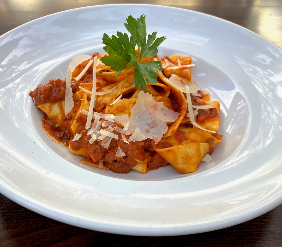 Lamb pappardelle with slow-braised lamb ragu, shaved cheese and parsley